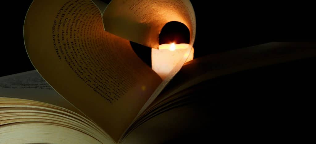 5 Things to Keep in Mind when Revising blog featured image book pages shaped like a heart with a candle in the end