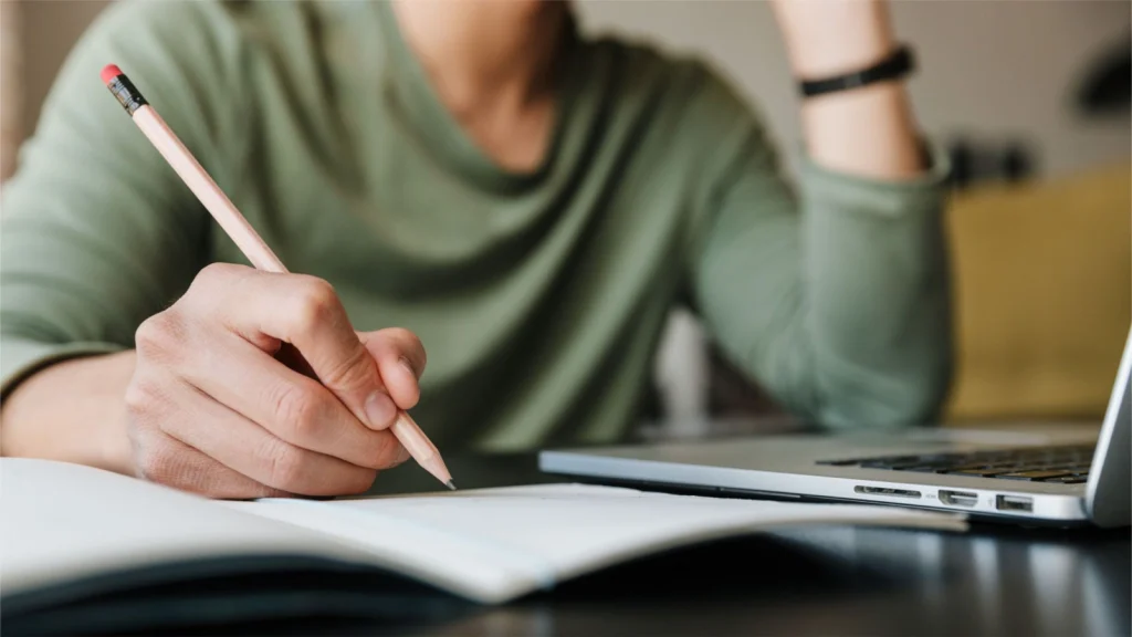 How to Come Up With the Perfect Lead Magnets for Your Book A person diligently taking notes on a notebook for the blog post 'how to come up with the perfect lead magnets for your book'
